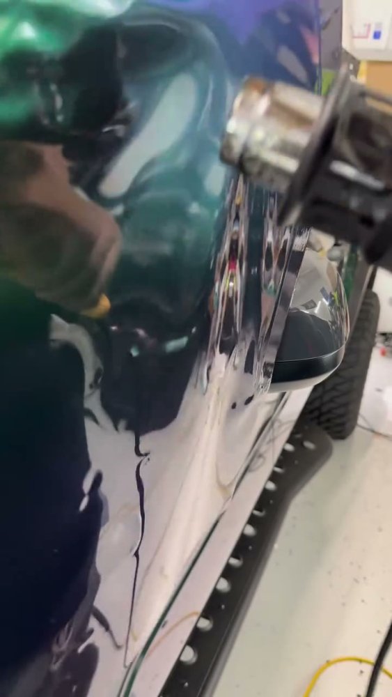 Green vinyl wrap on a Toyota Tacoma mirror - Aura Vinyl