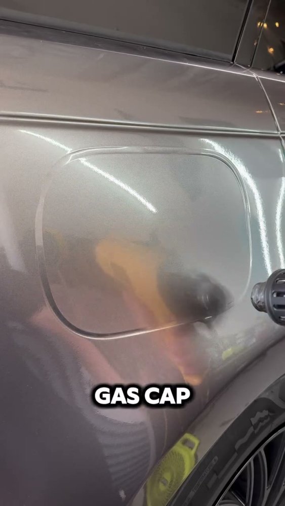 Grey vinyl wrap installation on a gas cap - Aura Vinyl