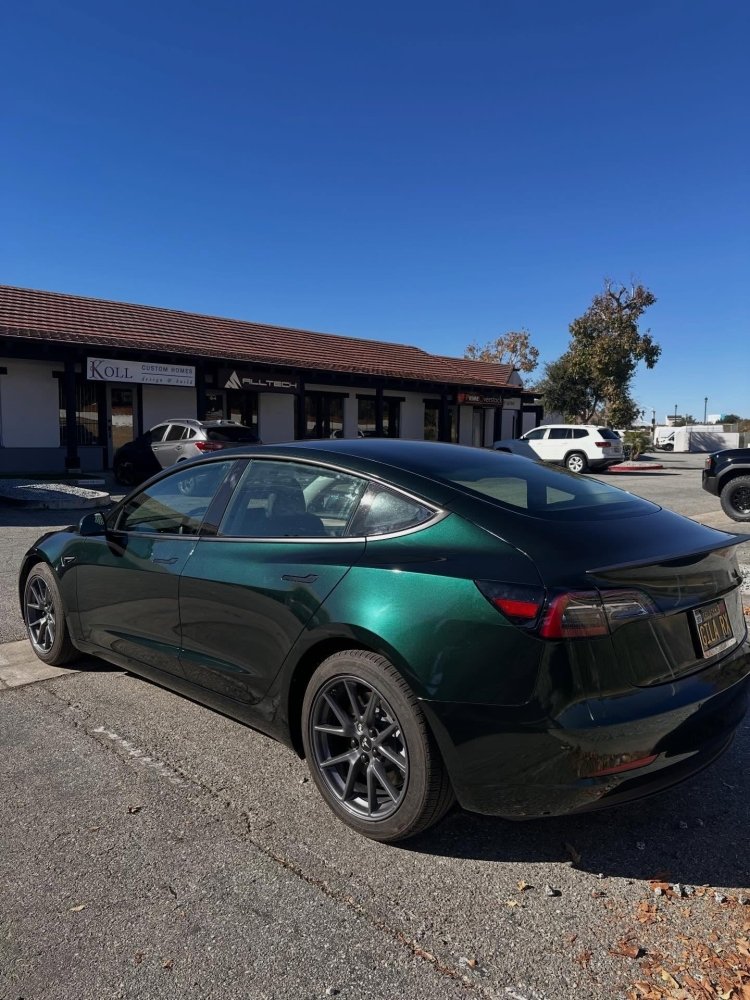 Glossy emerald green vehicle wrap.