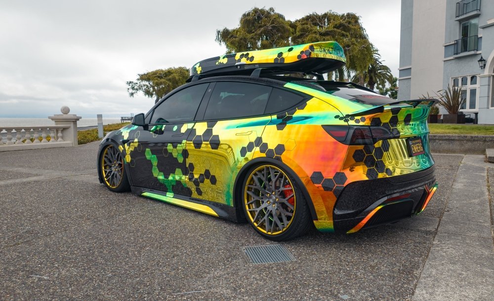 Colorful car with a unique design parked on a street.